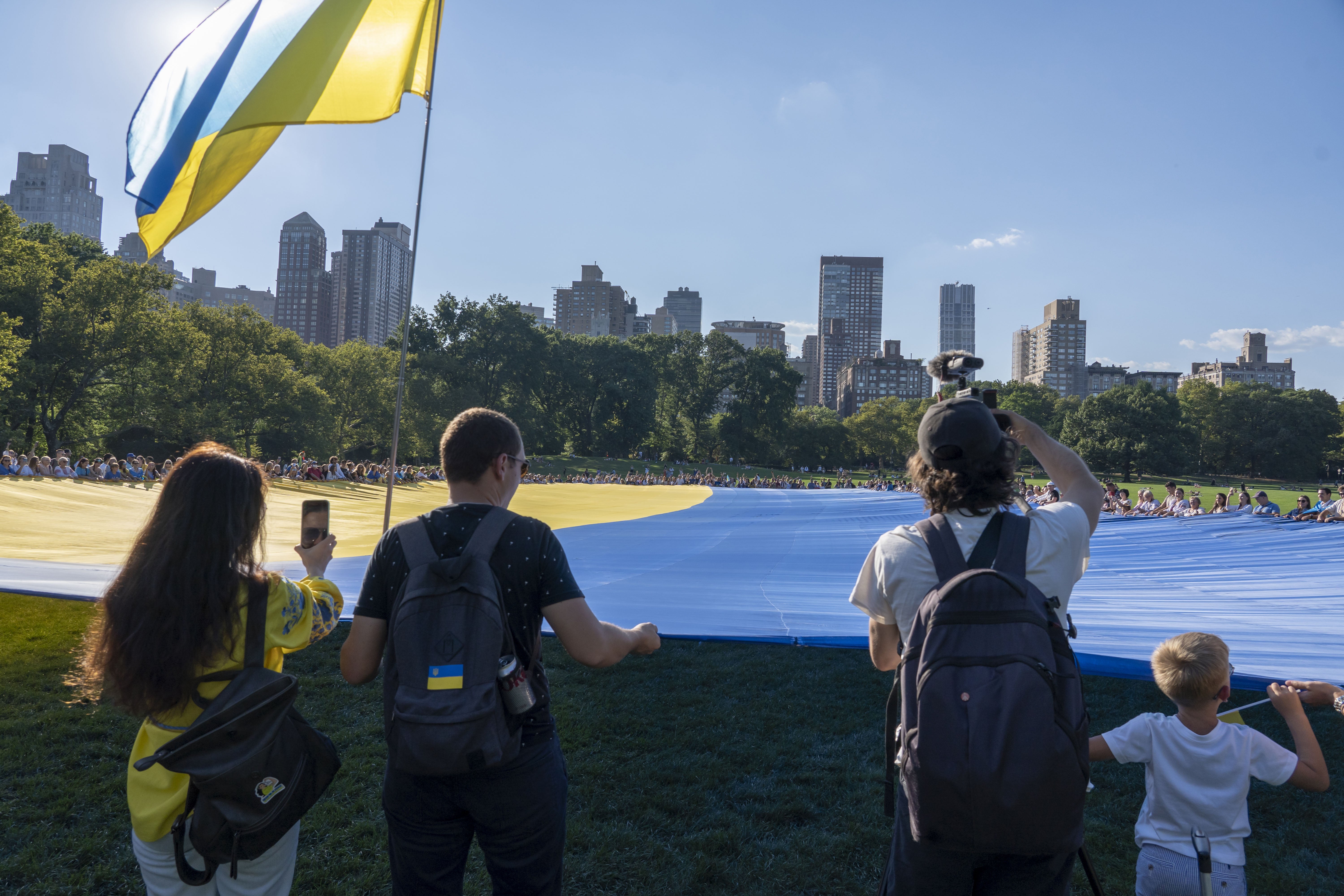 A giant Ukrainian flag is unfurled in Central Park, New York City.