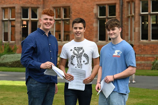 Alex Meyer (left), Charlie Pugh and James McConnell (right) who all achieved a straight set of A star/A’s in their GCSE’s at Campbell College, Belfast, Northern Ireland (Michael Cooper/PA)