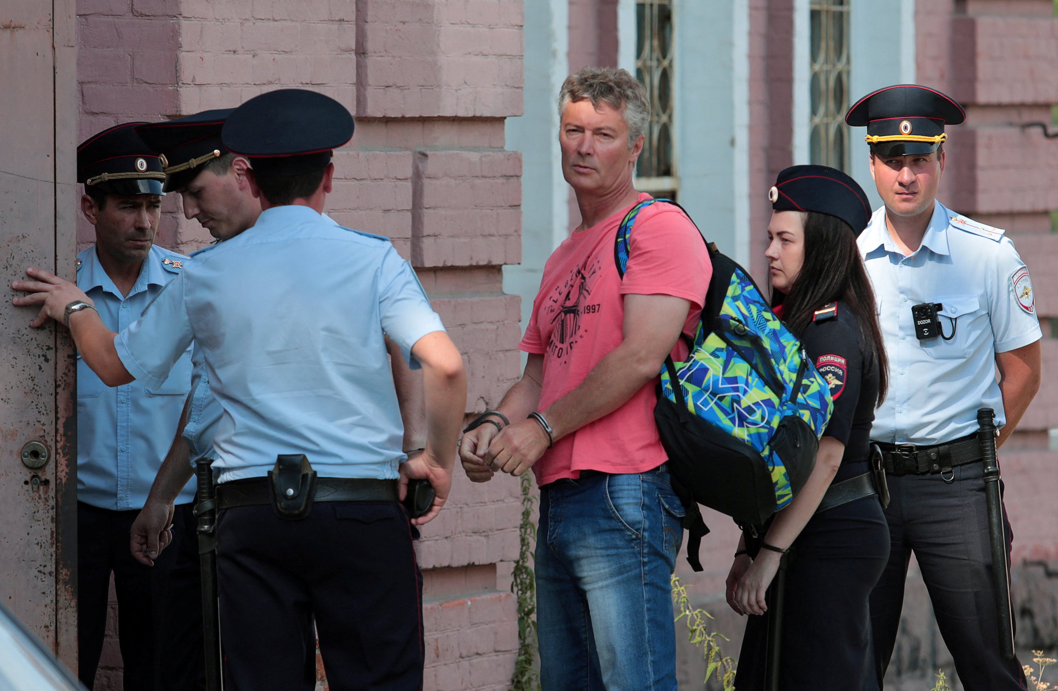 Kremlin critic Yevgeny Roizman is escorted to a court building in Yekaterinburg, Russia, on 25 August, 2022.