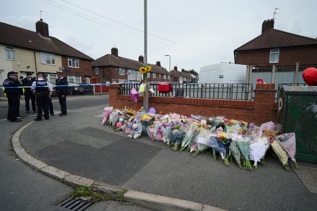 Flowers are left near to the scene of an incident in Kingsheath Avenue, Liverpool, where Olivia Pratt-Korbel was shot (Peter Byrne/PA)