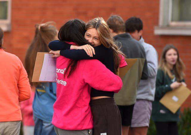 Pupils at Sullivan Upper School in Holywood, Co Down, celebrate after receiving their GCSE results (Oliver McVeigh/PA)