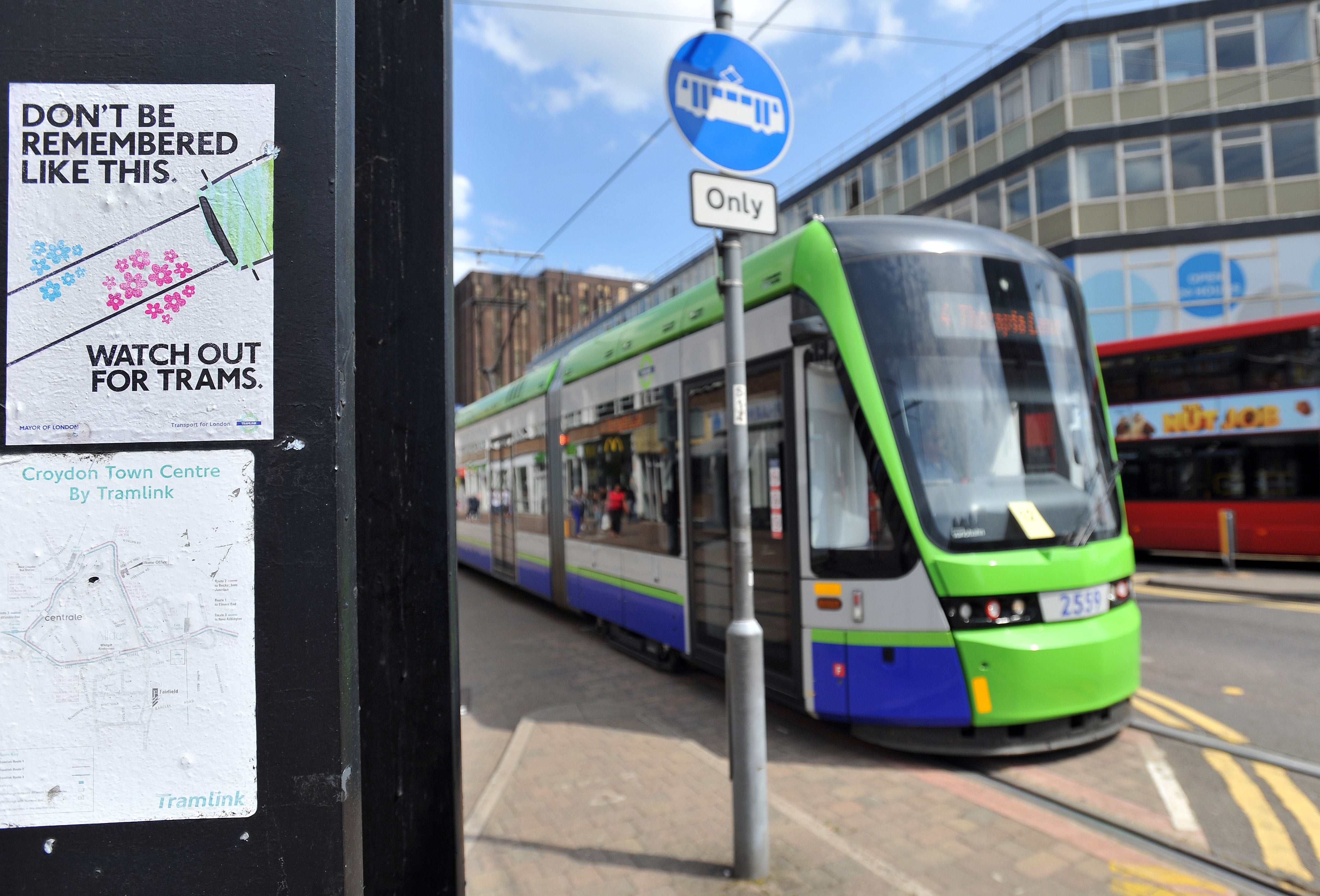 A Tramlink tram passes a warning sign on a post as it travels along George Street in Croydon, Surrey (Nick Ansell/PA)