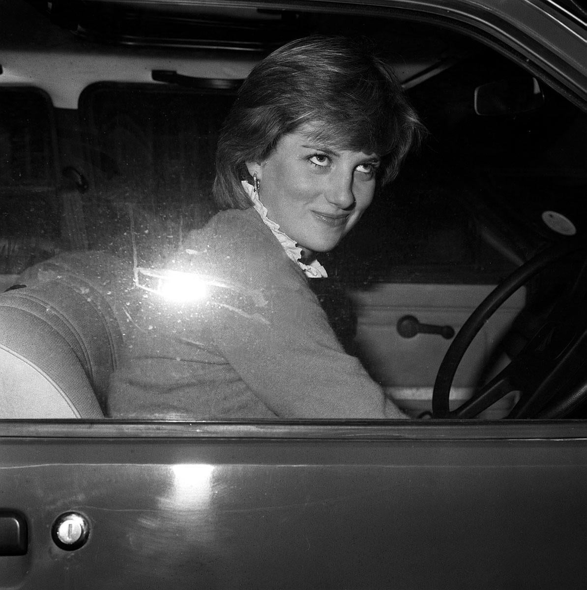 Lady Diana smiling at photographers after stalling her new car in in 1980 – amid mounting speculation over her relationship with the Prince of Wales (PA)