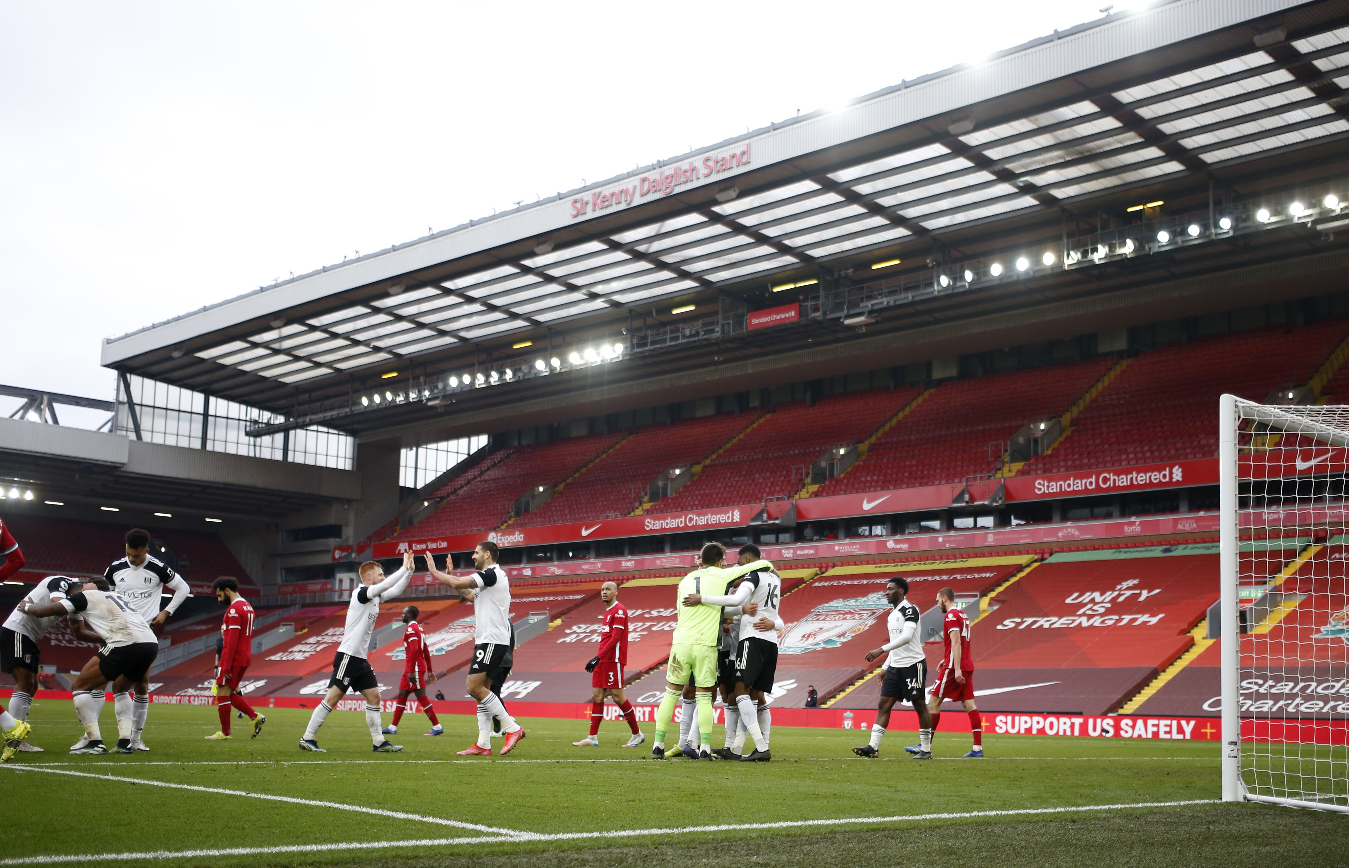 Fulham celebrate victory at an empty Anfield last March (Phil Noble/PA)