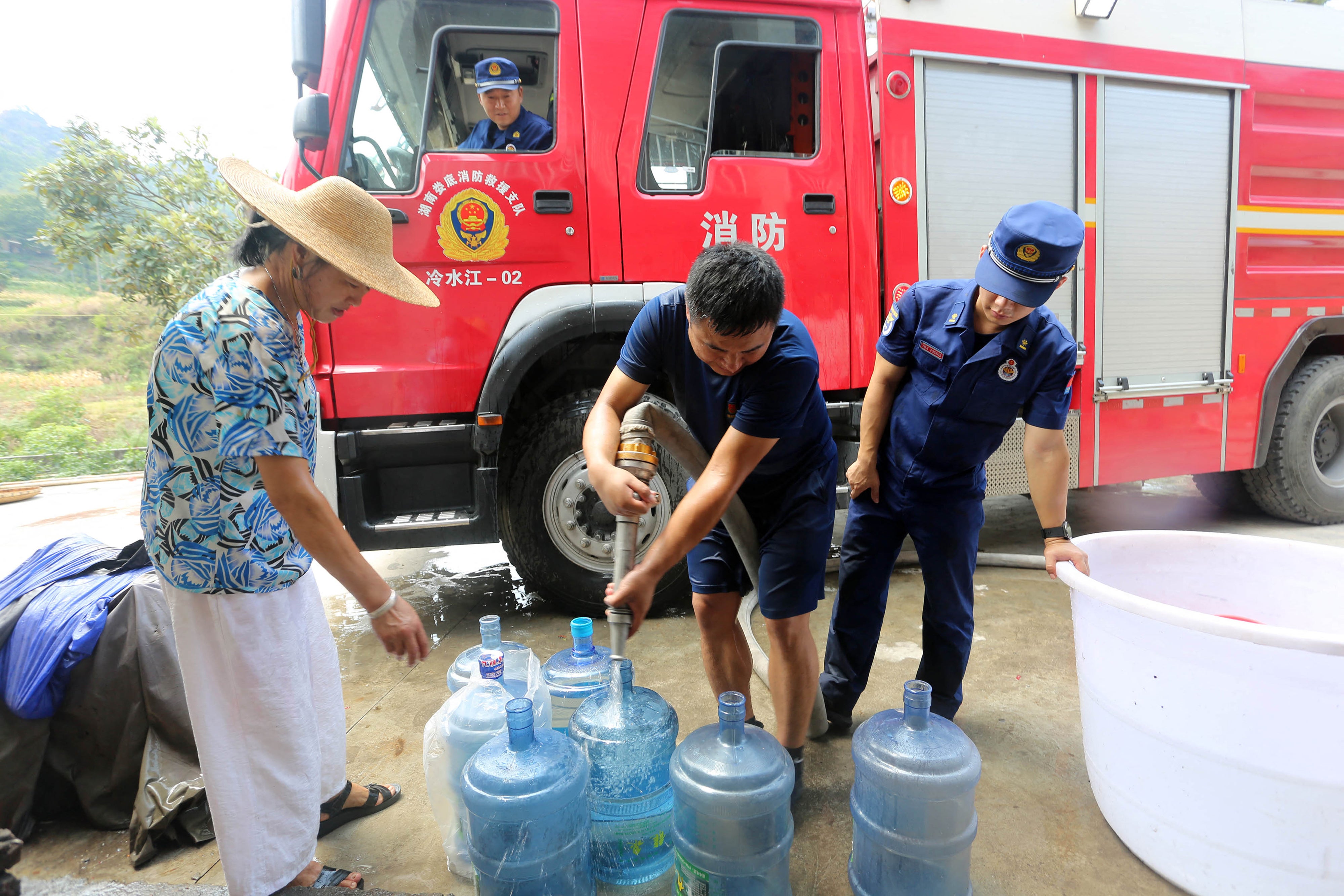 Firefighters delivering water to residents due to a shortage amid heatwave conditions, in Loudi in China’s central Hunan province