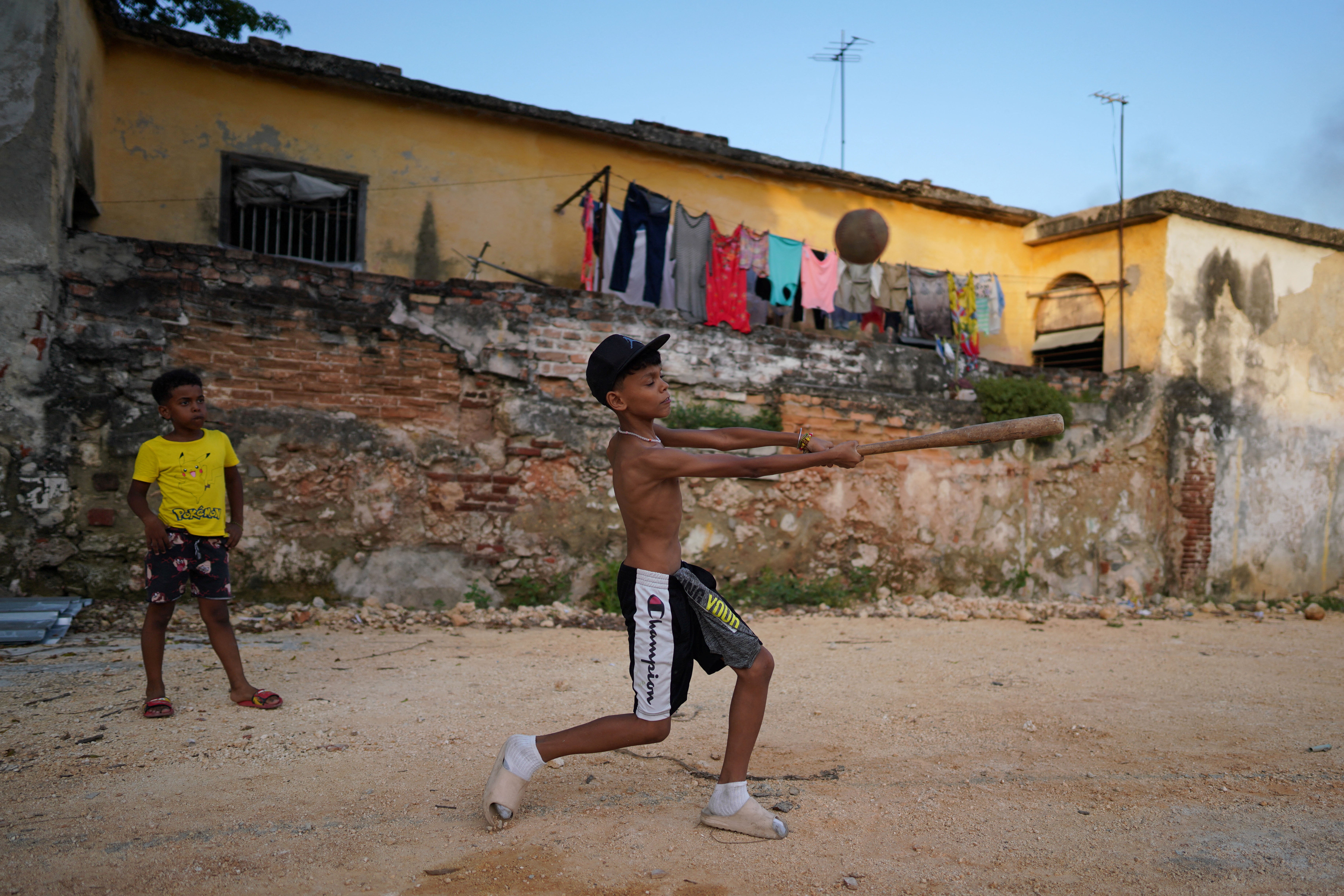 Kevin plays with friends at a vacant lot in Havana