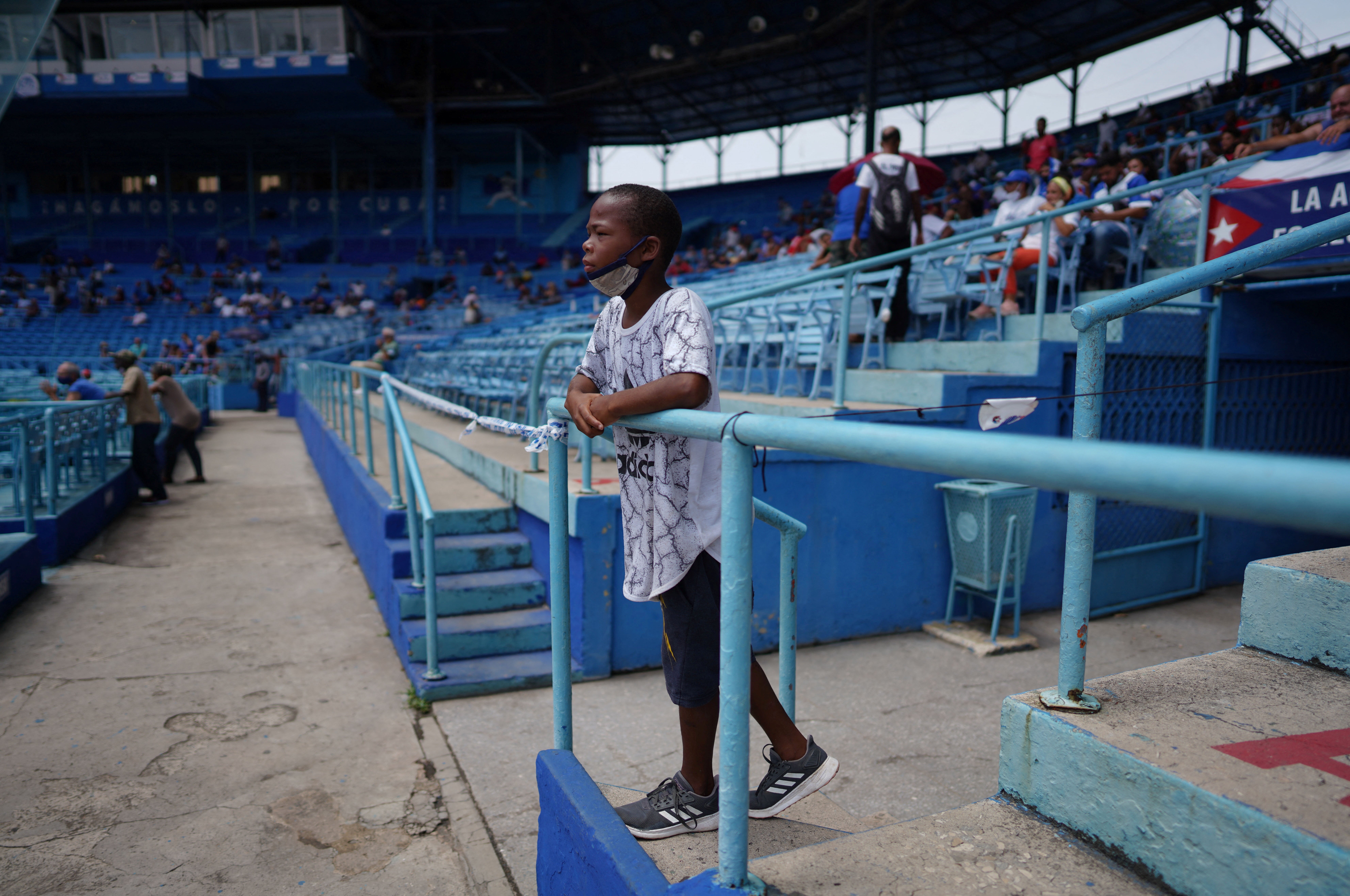 A child watches a baseball match between Industriales and Artemisa