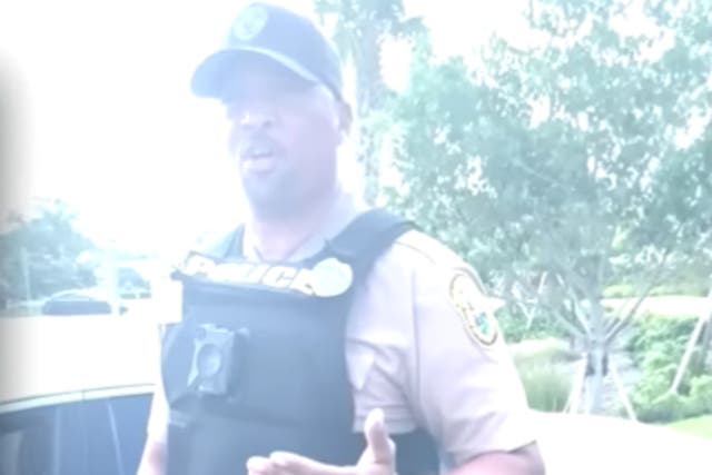 <p>A Miami-Dade Police Department officer identifying himself as ‘Officer Daniels’ argues with Kevin Enciso outside a hospital in Florida. </p>