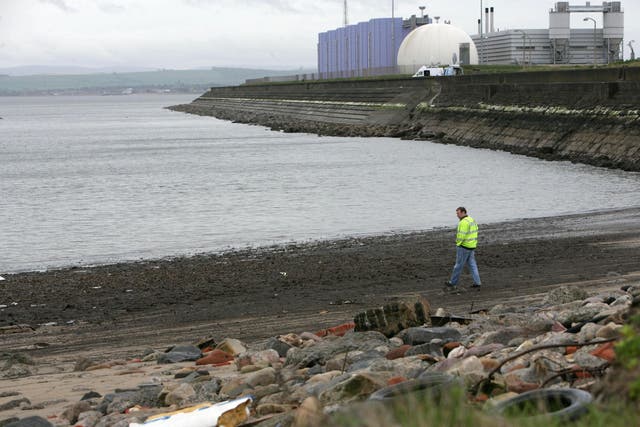 A Scottish Water official examines Seafield beach and the outflow pipe where raw sewage was pumped into the Forth Estuary (Toby Williams/PA)