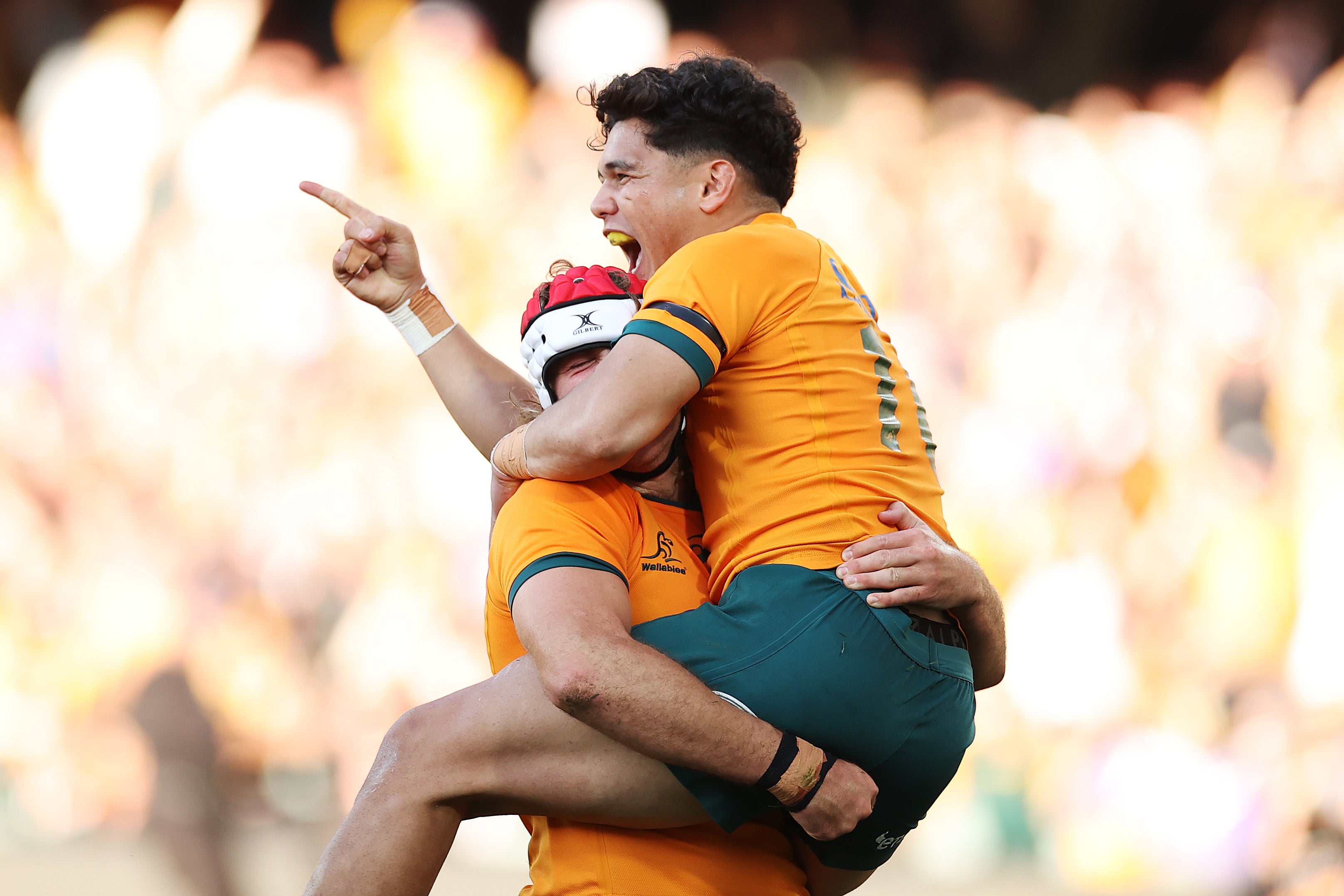 Noah Lolesio of the Wallabies celebrates with try-scorer Fraser McReight