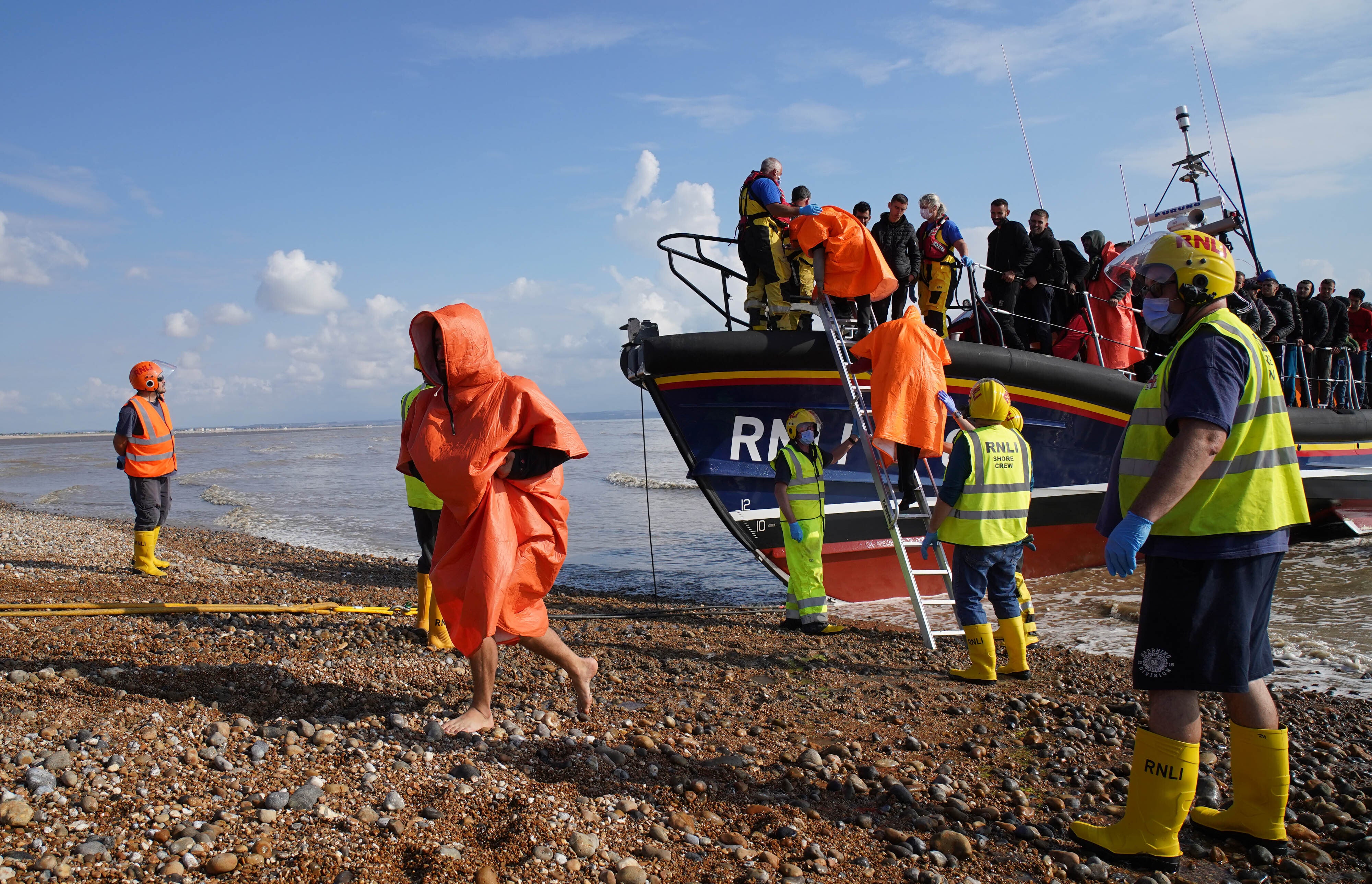 A group of people thought to be migrants are brought in to Dungeness, Kent, onboard an RNLI lifeboat (Gareth Fuller/PA)