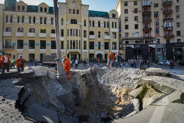 <p>An overnight Russian rocket attack leaves a huge crater and damaged buildings in downtown Kharkiv on Saturday</p>