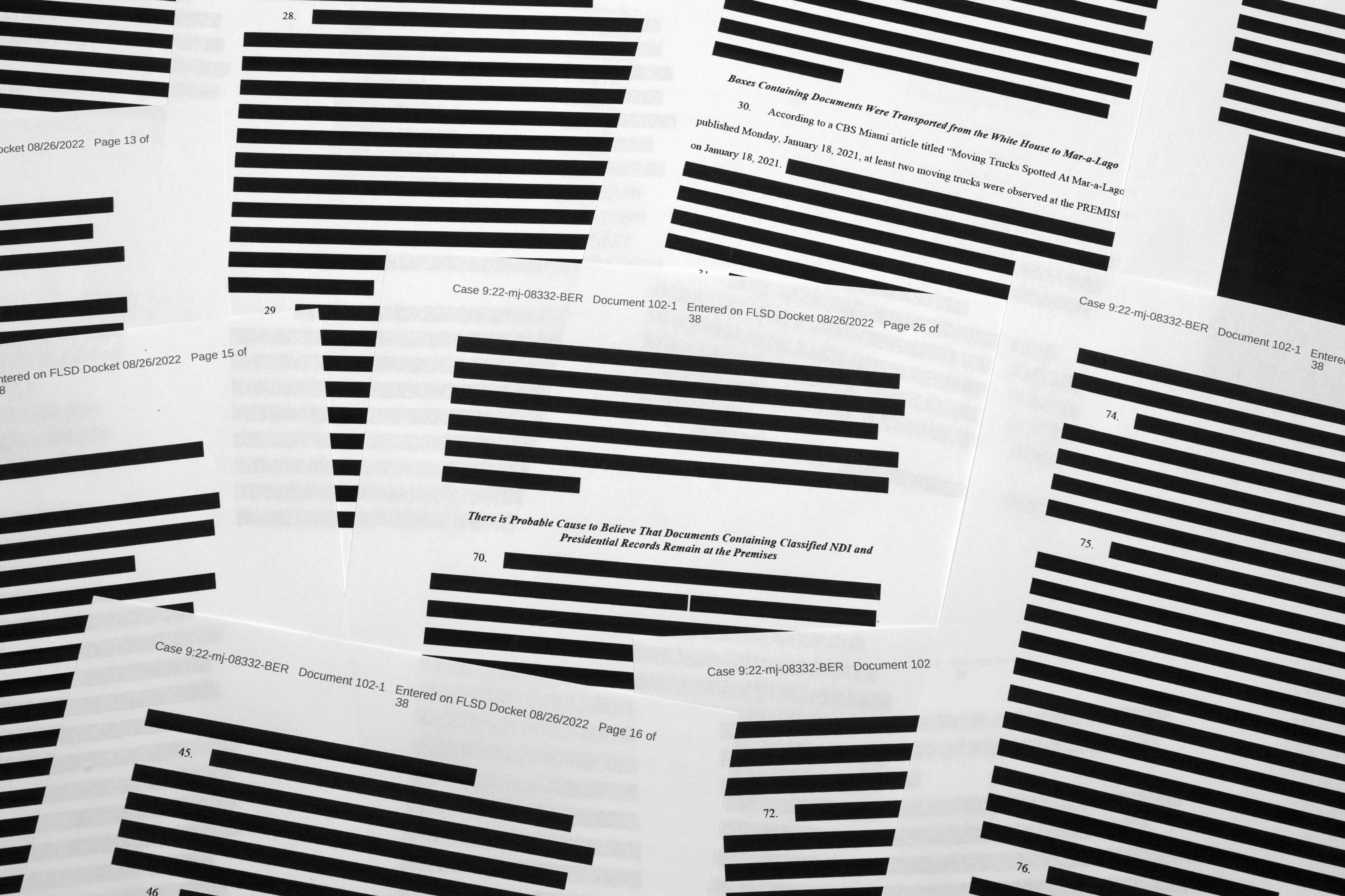 Pages from the affidavit from the FBI, with multiple redactions