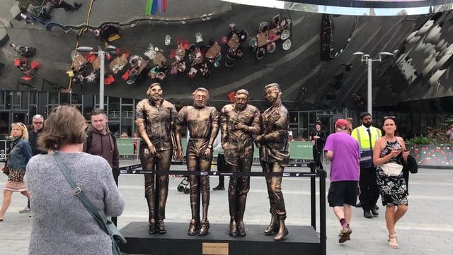 <p>Viral 'four lads in jeans' have statue unveiled in their honour</p>
