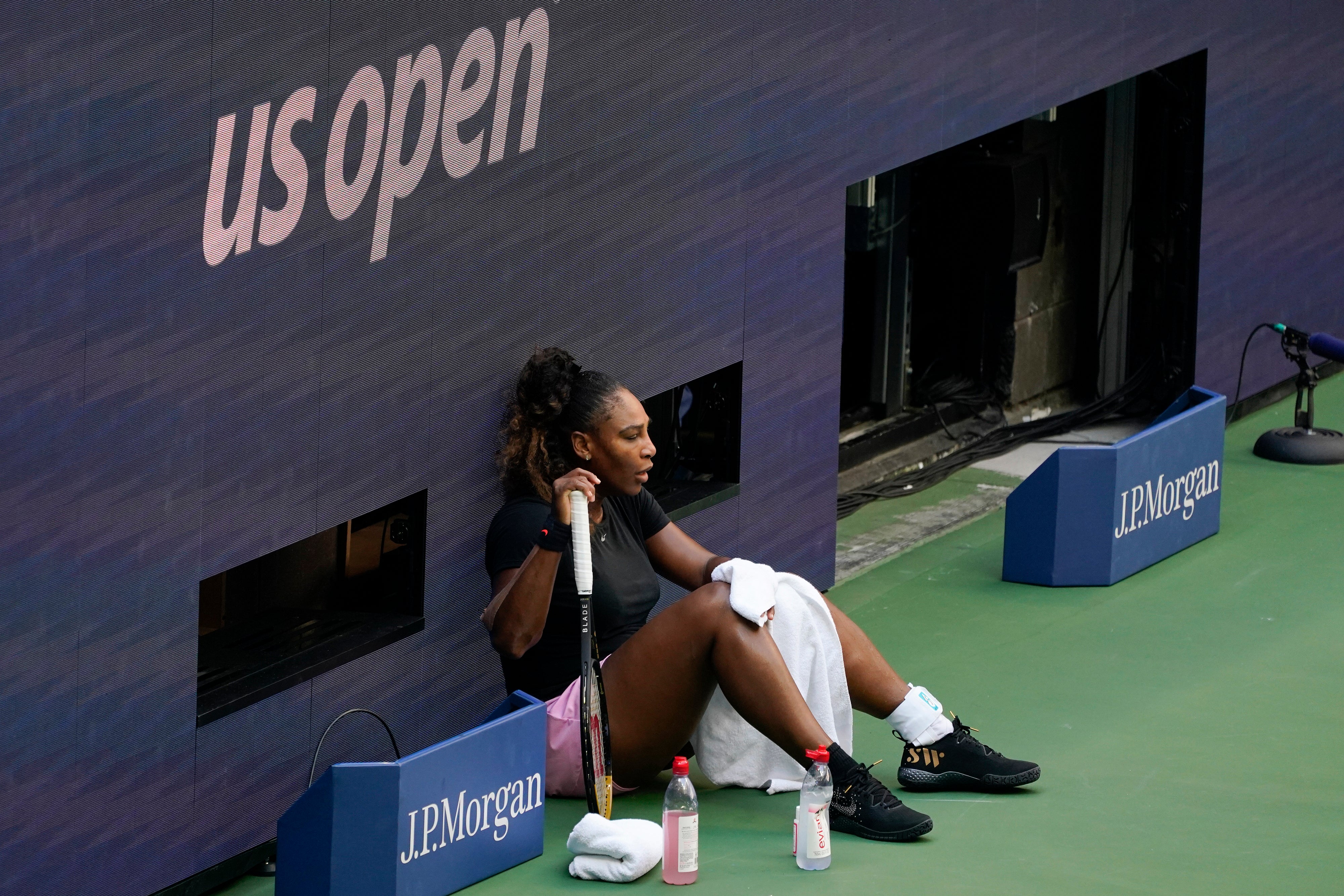 Serena Williams rests while practicing at Arthur Ashe Stadium before the start of the U.S. Open tennis tournament in New York, Thursday, Aug. 25, 2022. (AP Photo/Seth Wenig)