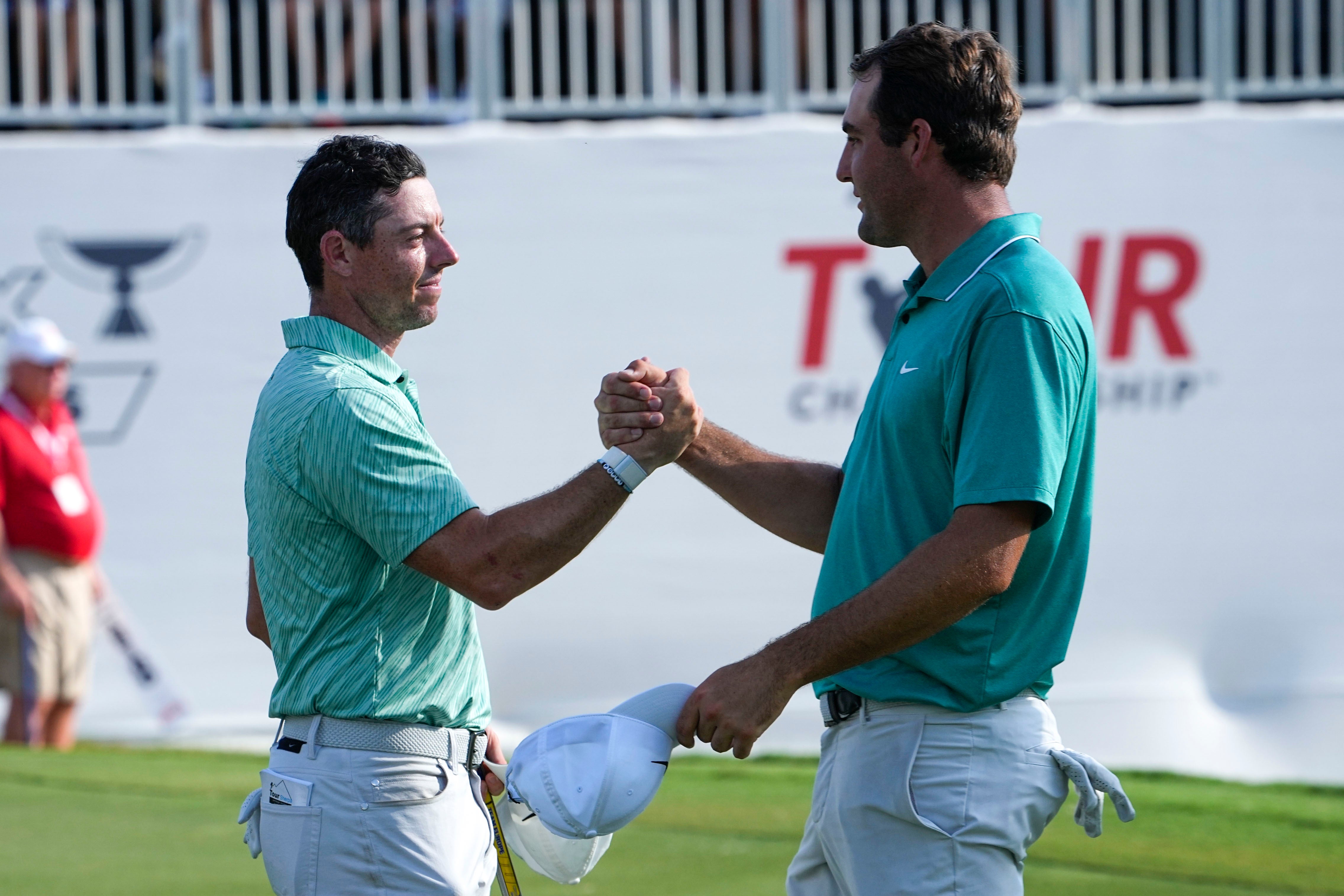 Rory McIlroy (left) shakes hands with Scottie Scheffler after winning the Tour Championship and FedEx Cup in Atlanta (Steve Helber/AP)