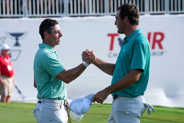 Rory McIlroy (left) shakes hands with Scottie Scheffler after winning the Tour Championship and FedEx Cup in Atlanta (Steve Helber/AP)