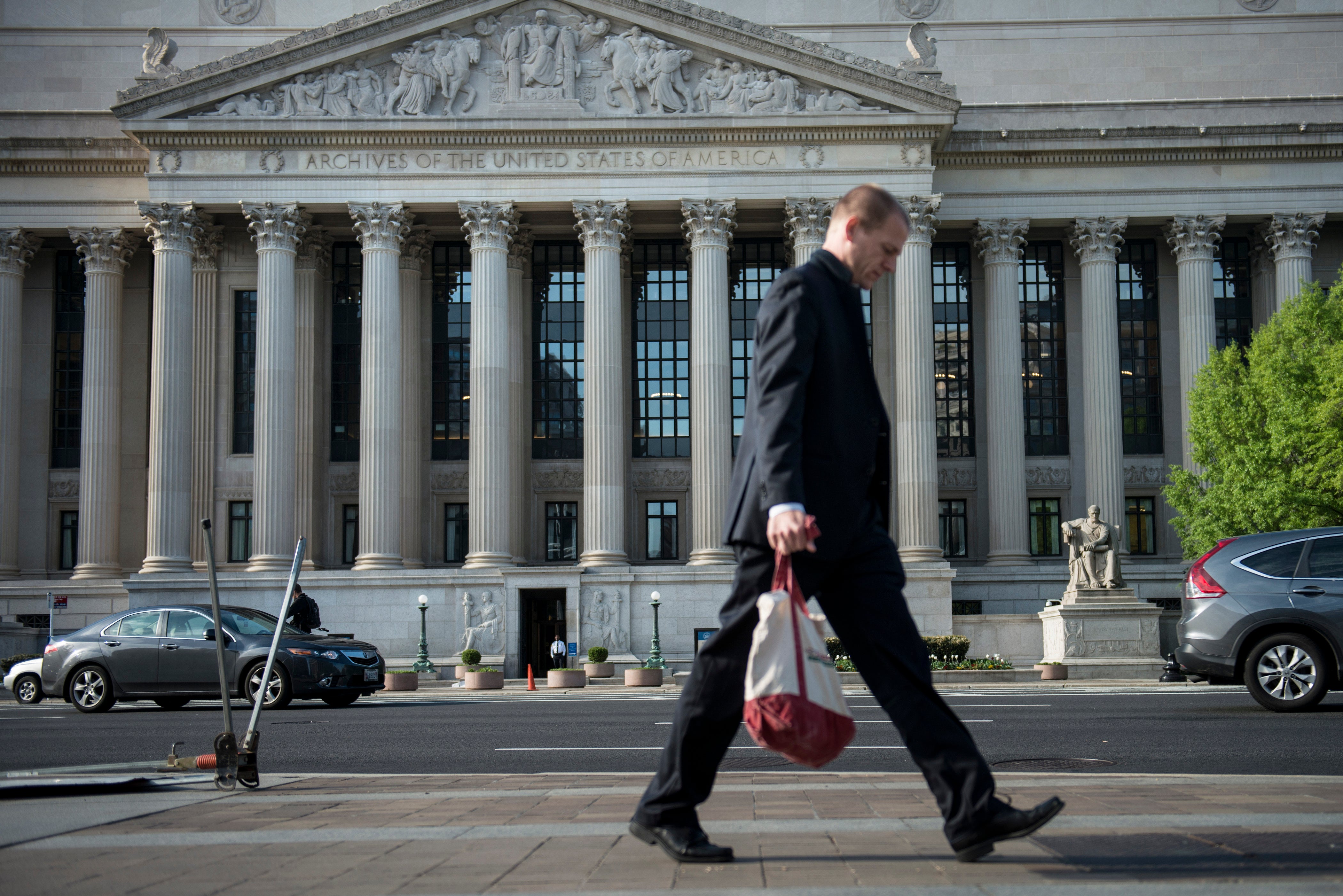 A man walks past the US National Archives and Records Administration headquarters in Washington, DC