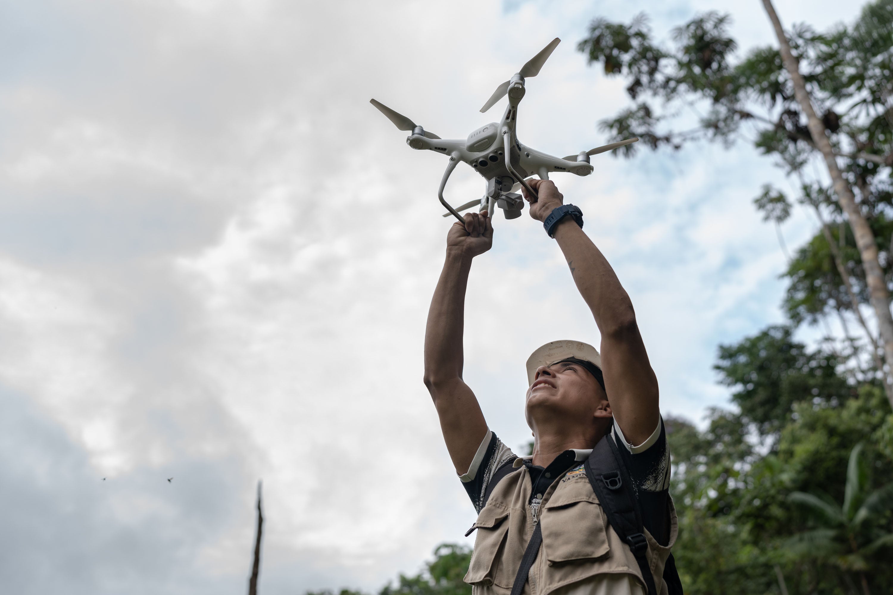 A monitor launches a drone to survey the illegal coca crop in Ucayali