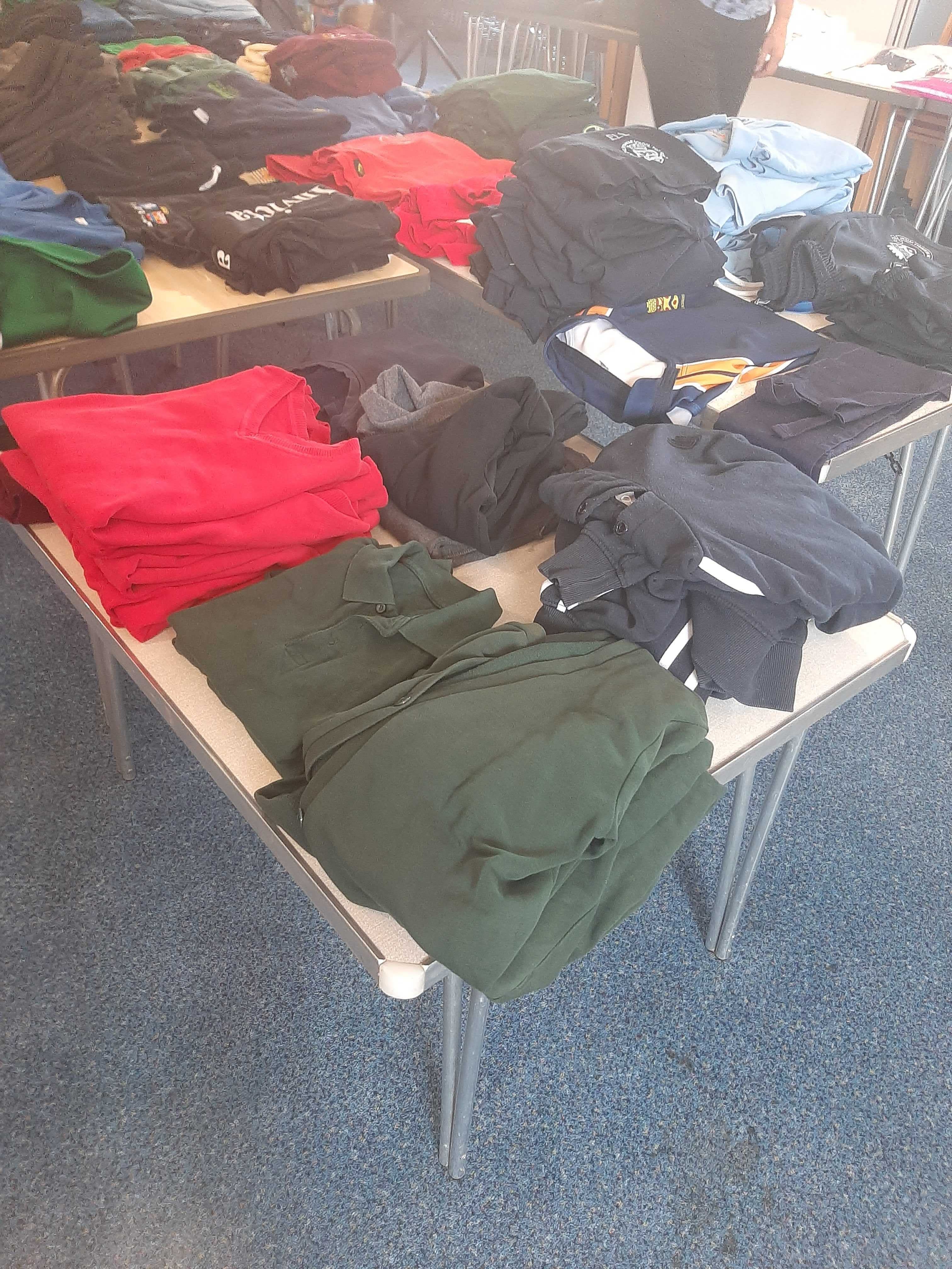 Rows of different uniforms were laid out on tables at the uniform bank in Kent