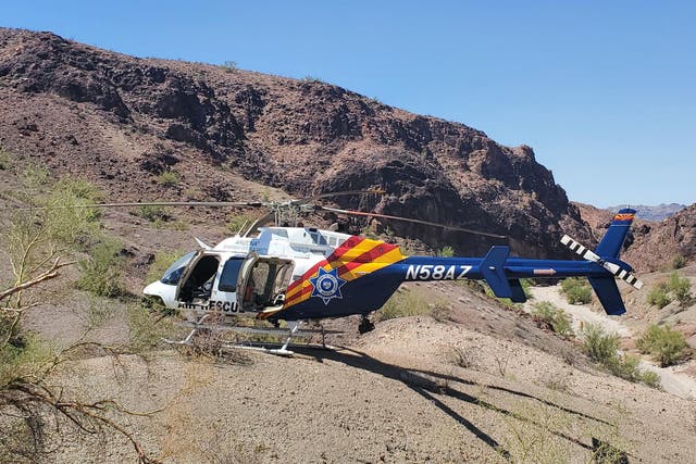 <p>A helicopter involved in the search for hikers near Lake Havasu City. A man in Laguna Niguel, California, is in custody after attempting to shoot at an Orange County Sheriff’s Department helicopter </p>