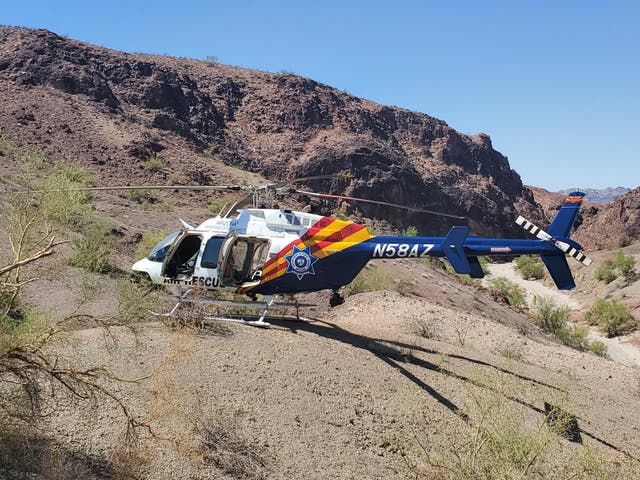 <p>A helicopter involved in the search for hikers near Lake Havasu City. A man in Laguna Niguel, California, is in custody after attempting to shoot at an Orange County Sheriff’s Department helicopter </p>