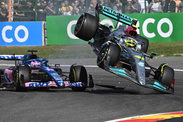 <p>Mercedes' British driver Lewis Hamilton (R) collides with Alpine's Spanish driver Fernando Alonso (C) during the Belgian Formula One Grand Prix at Spa-Francophones racetrack at Spa</p>