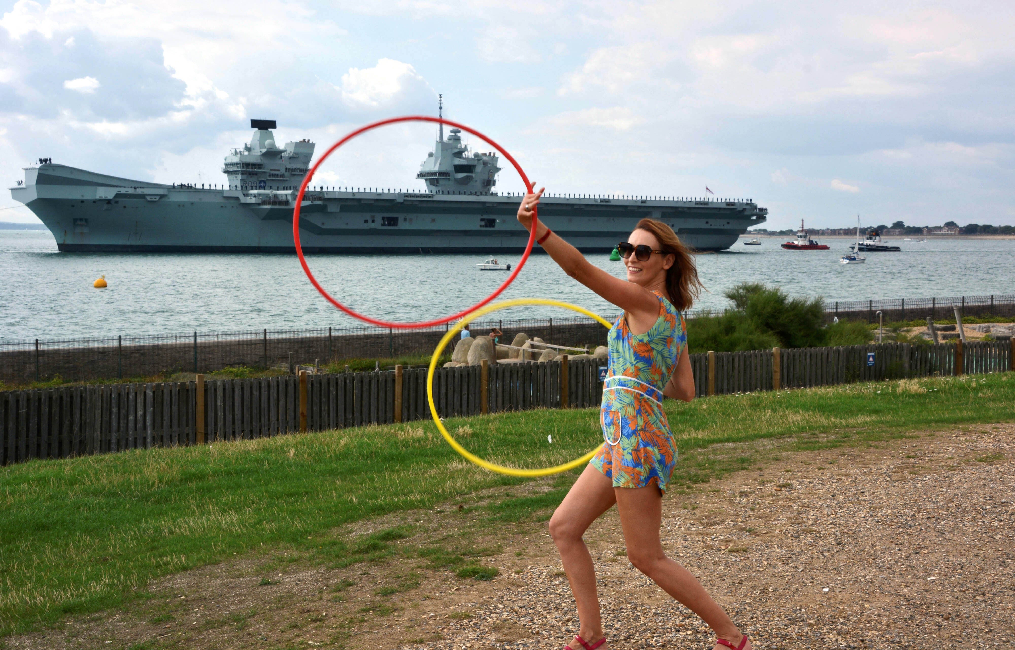 <p>Festival goers at the Victorious Festival on Southsea Common gave Royal Navy aircraft carrier HMS Prince of Wales a colourful send-off (Ben Mitchell/PA)</p>