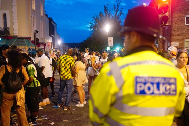 <p>Carnival-goers at the Notting Hill Carnival in London, which returned to the streets for the first time two years after it was thwarted by the pandemic (PA)</p>