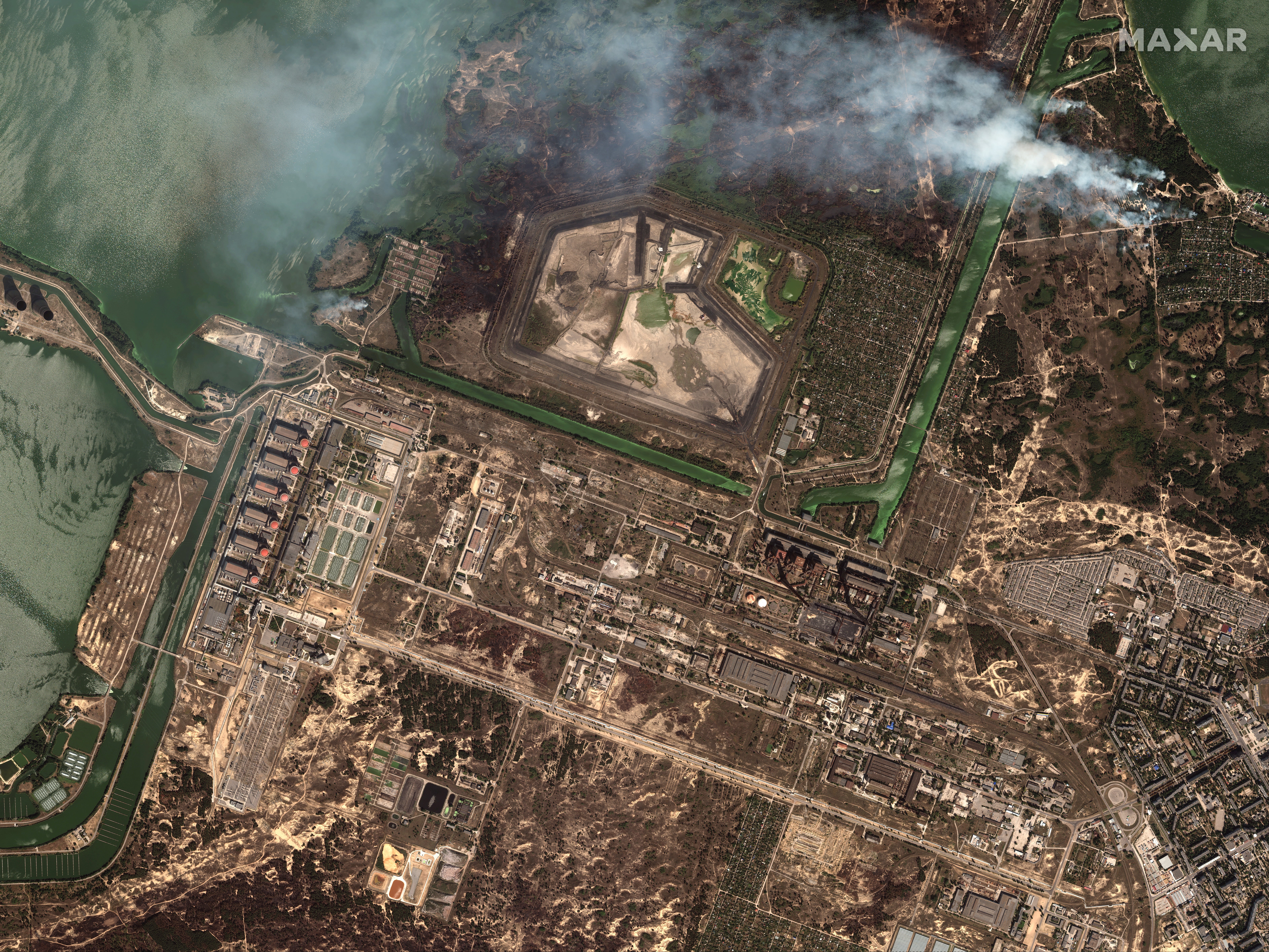 An overview image of Zaporizhzhia nuclear power plant complex shows clouds of smoke hovering over the area