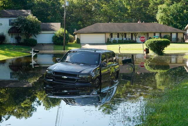 <p>An SUV rests in flood waters in this northeast Jackson, Mississippi neighborhood on Monday, August 29, 2022. Flooding affected a number neighborhoods that are near the Pearl River</p>