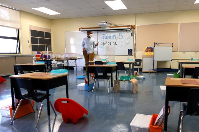 <p>Bryant Elementary School kindergarten teacher Chris Johnson sets up his classroom on April 09, 2021 in San Francisco, California</p>