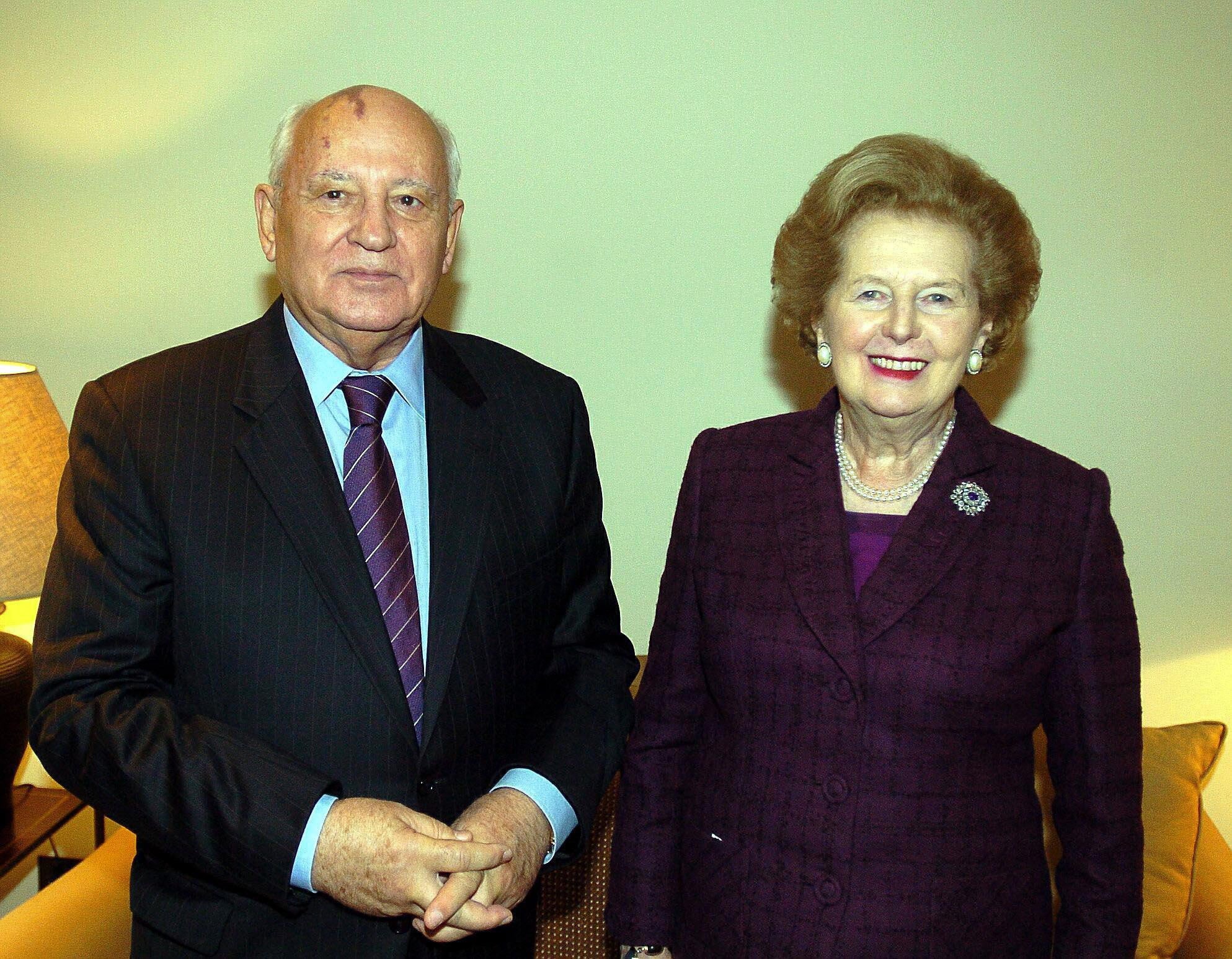 Mikhail Gorbachev stands with Lady Thatcher in 2005