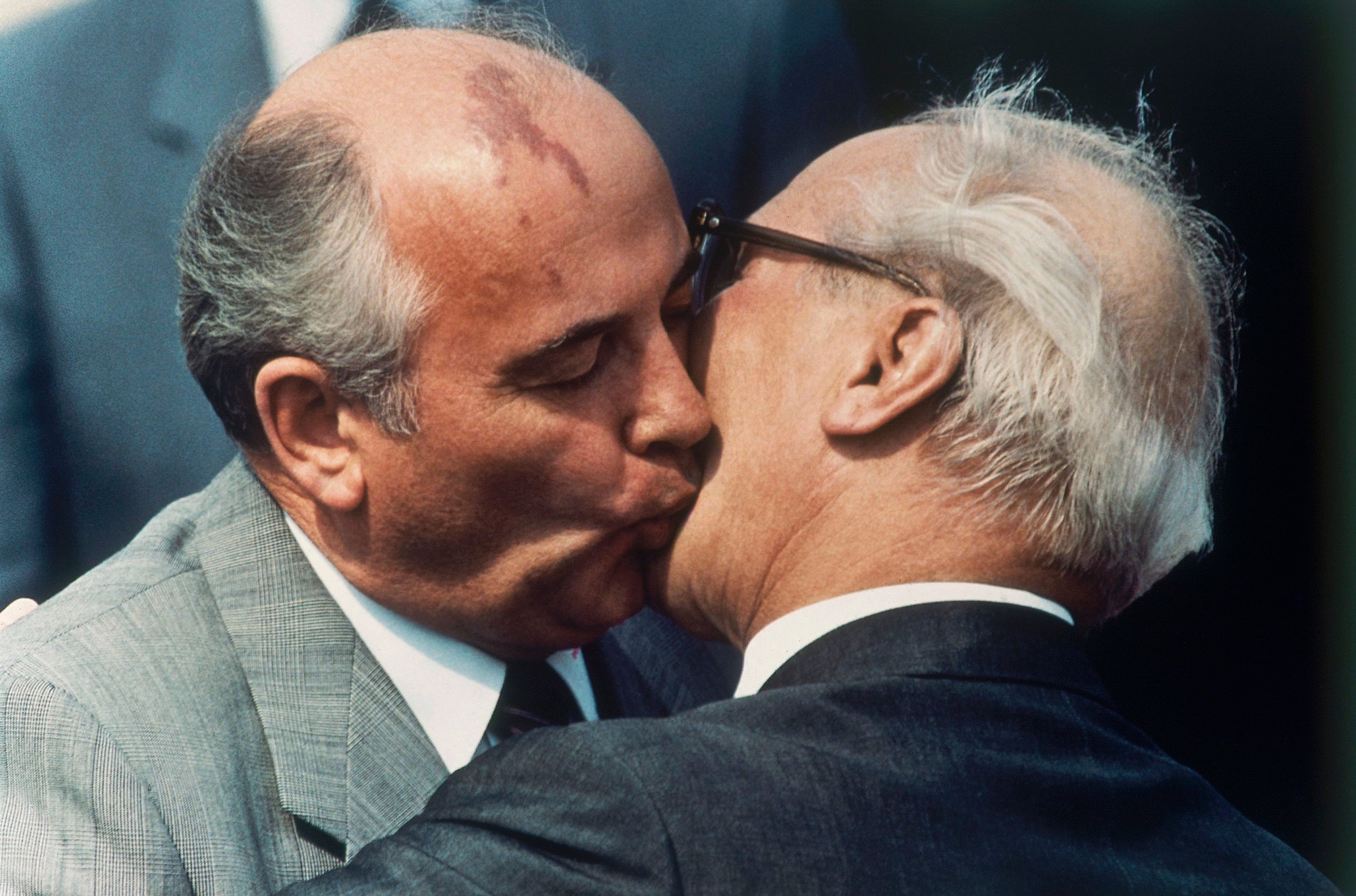 Soviet Communist Party leader Mikhail Gorbachev, left, and East Germany's state and Communist party leader Erich Honecker exchange kisses at East Berlin's Schoenefeld airport on Wednesday May 27, 1987