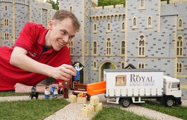 Legoland Windsor Resort Model Maker Will Metcalfe finalises the display of Lego figures of the Duke and Duchess of Cambridge as they are unveiled at Legoland Windsor to celebrate the royal couple moving to the local area with their family (Jonathan Brady/PA)