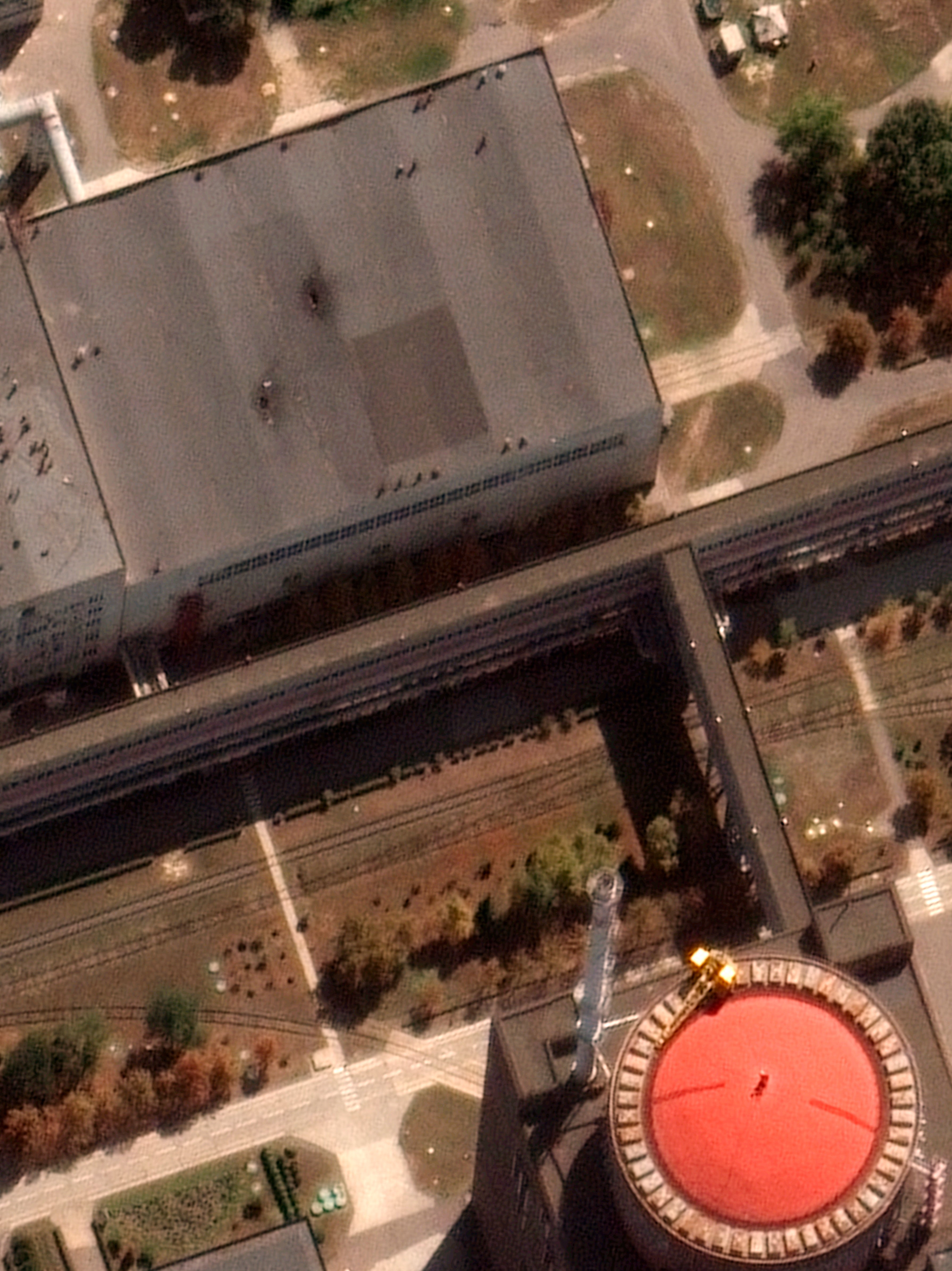 Satellite image from Maxar Technologies shows recent damage to the roof of a building adjacent to a nuclear reactor (red top) at Zaporizhzhia