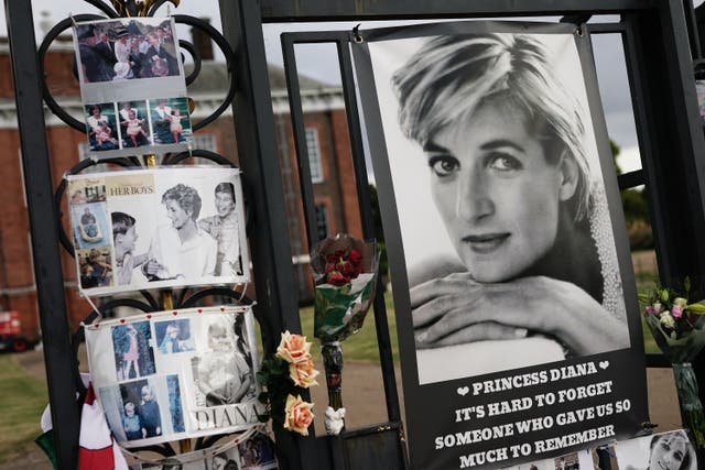 Tributes are left on the gates outside Kensington Palace, London (Aaron Chown/PA)