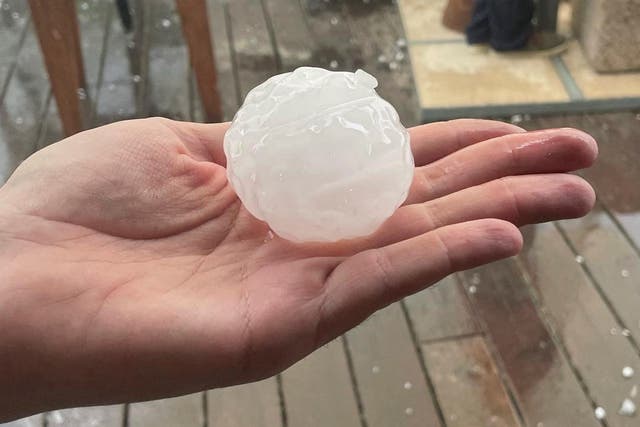<p>A person holds up a hailstone during a hailstorm in Girona, Spain on 30 August, 2022</p>