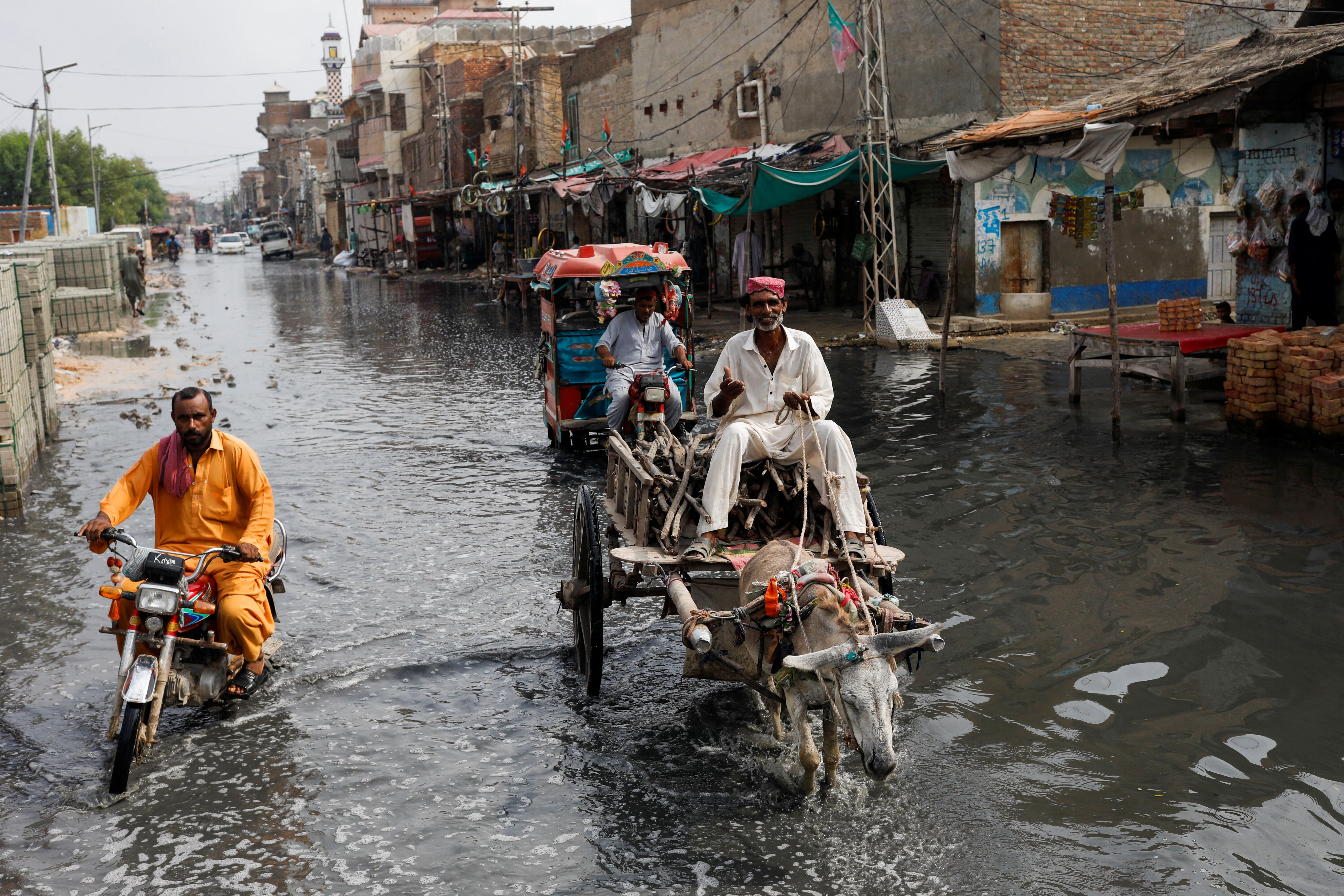 A man rides on donkey cart through rain waters, following rains and floods during the monsoon season in Jacobabad, Pakistan on Tuesday.