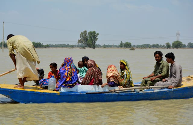 <p>Displaced people are transported through floodwaters by boat, in Multan, Pakistan, Wednesday.</p>