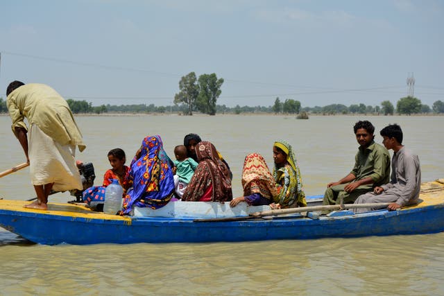<p>Displaced people are transported through floodwaters by boat, in Multan, Pakistan, Wednesday.</p>