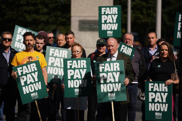 Seamus Dooley (centre right), NUJ Irish secretary, with union members and supporters on O’Connell Street (Brian Lawless/PA)