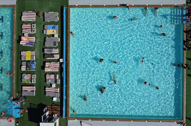 <p>File: people relax in a swimming pool on a summer day</p>