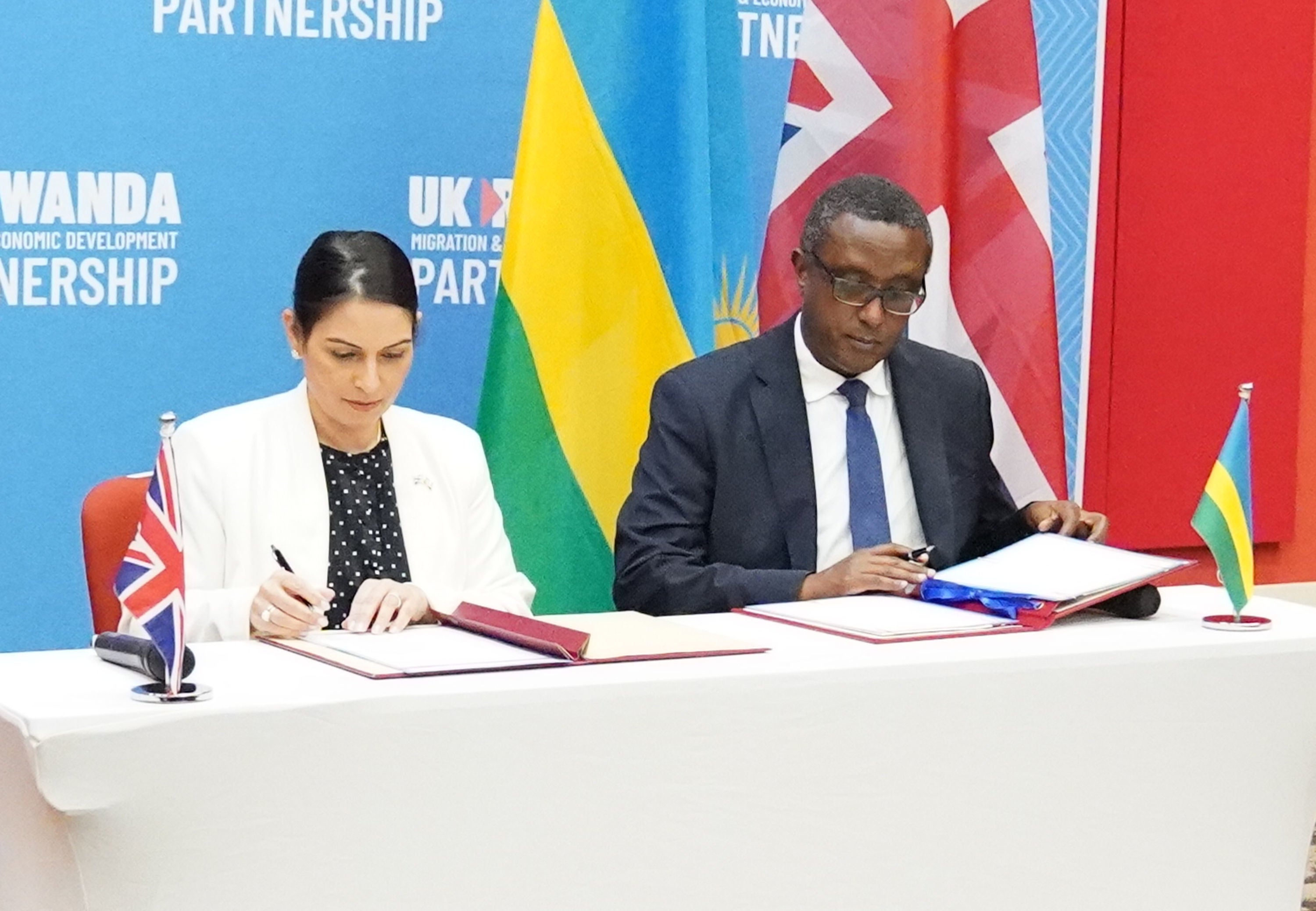 Priti Patel and Rwandan minister for foreign affairs and international cooperation Vincent Biruta sign a migration and economic development partnership in Kigali in April