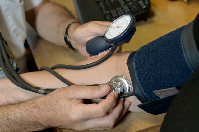 A doctor checking a patient’s blood pressure, as over half of UK adults cannot name a single symptom of blood cancer despite it being the third biggest cancer killer in the UK, polling for Blood Cancer UK suggests (Anthony Devlin/PA)
