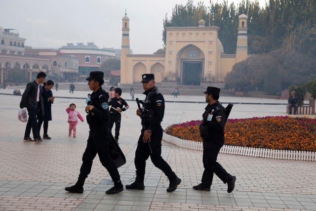 <p>Uyghur security personnel patrol near the Id Kah Mosque in Kashgar in western China’s Xinjiang region</p>
