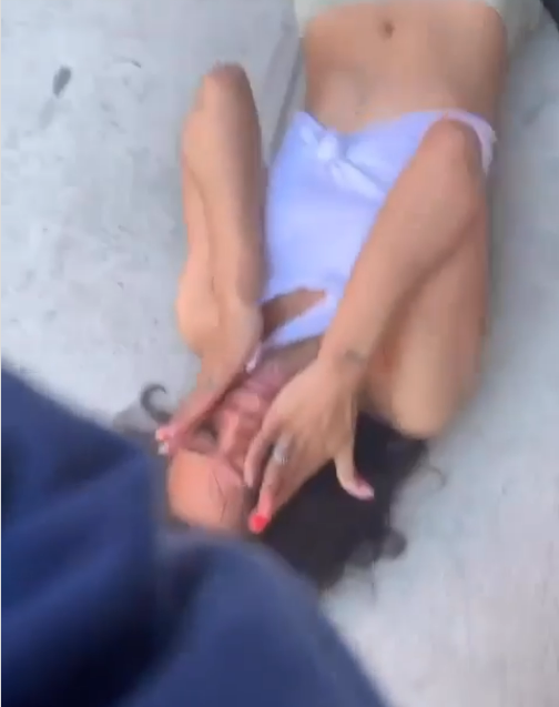Tamani Crum is seen writhing in pain on the pavement after getting knocked to the ground by an officer’s punch to the face