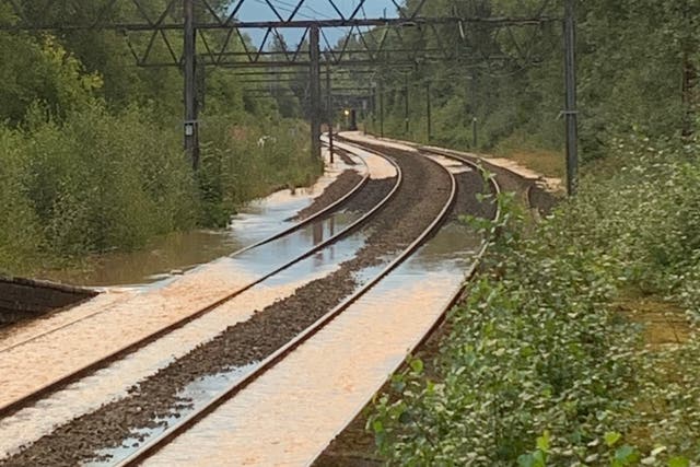 Train services in parts of northern England are severely disrupted after a burst water main flooded tracks (Network Rail/PA)