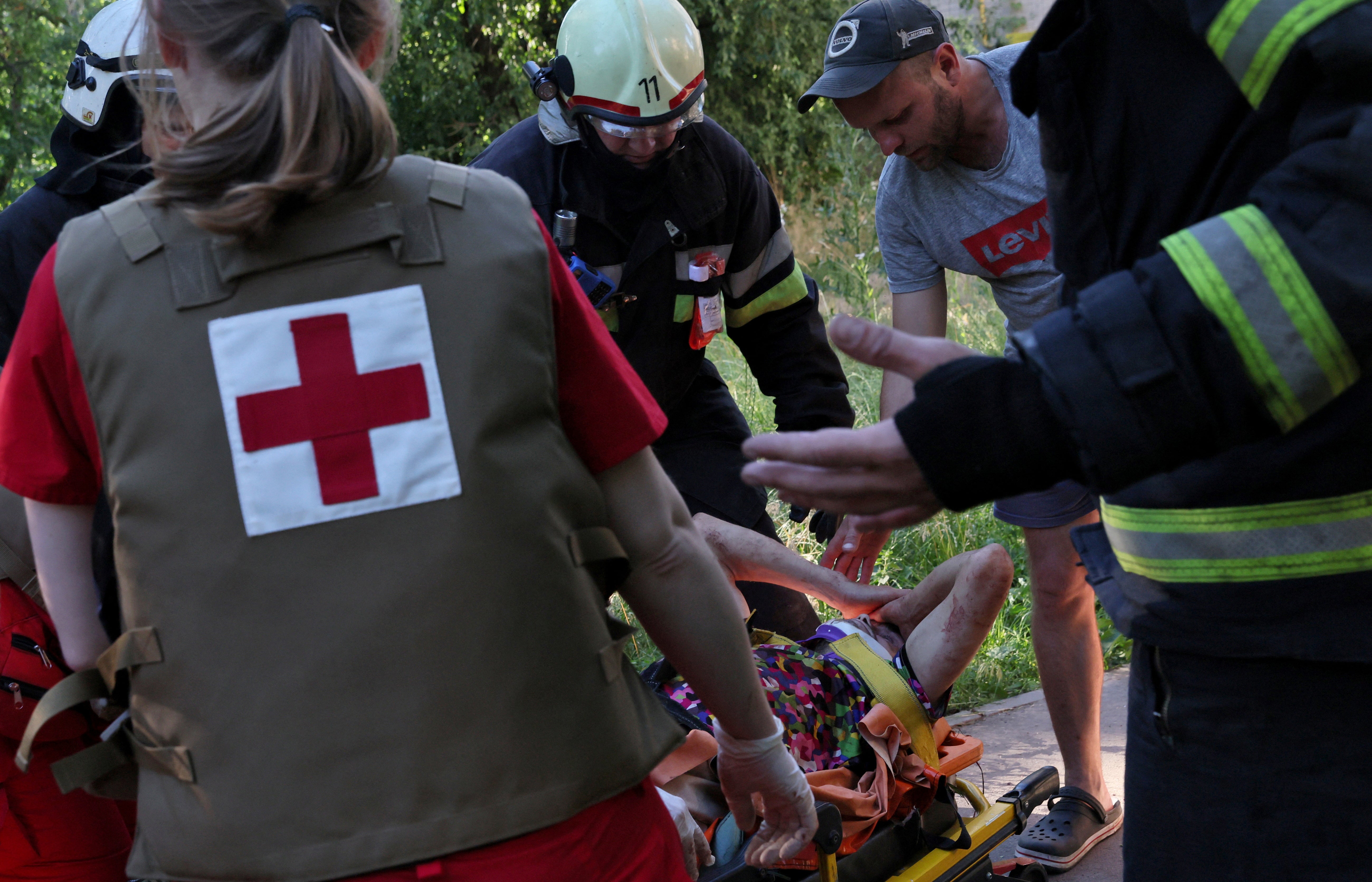 An injured person is rescued from bombed apartments