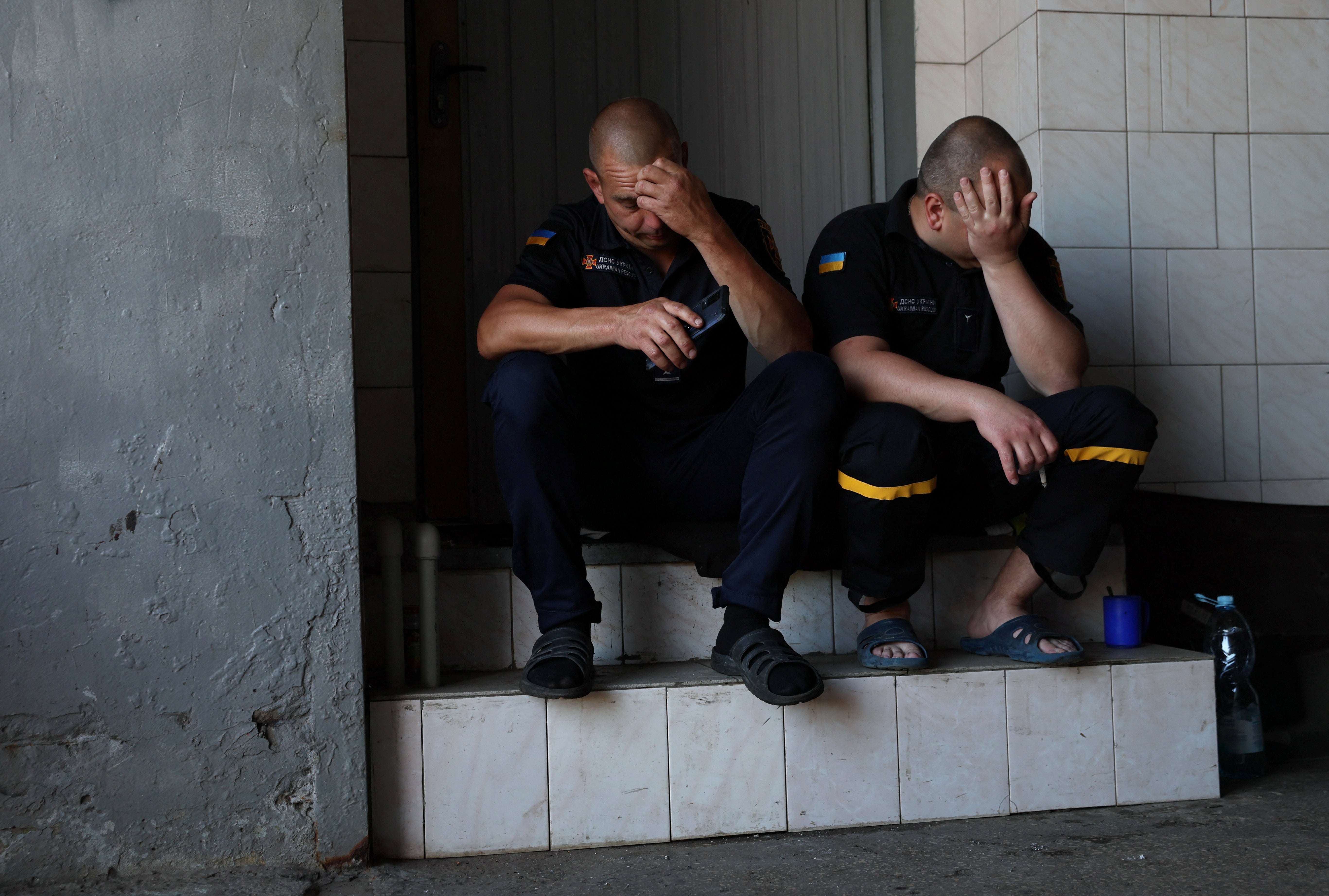 Exhausted: firefighters Dima and Nikolay take a break